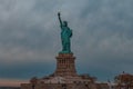 Breathtaking view of the Statue of Liberty against the dark cloudy sky Royalty Free Stock Photo