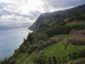 Breathtaking view with steep cliffs, sea, alcove and flower garden from the viewpoint Miradouro da Ponta do Sossego at