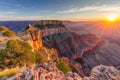 A breathtaking view of the sun slowly descending behind the magnificent Grand Canyon, A breathtaking view of the Grand Canyon at Royalty Free Stock Photo