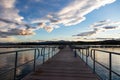 Sunrise sunset gazing from wooden pier over sea, copy space, wallpaper. Royalty Free Stock Photo