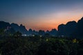 Breathtaking view of a sunset in Guilin Landscapes in Yangshuo, China captured on a foggy day Royalty Free Stock Photo