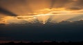 Dramatic Sunset Sky with Sun Rays Bursting Through Dark Clouds light Royalty Free Stock Photo