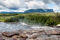 Scenic landscape of wild and pristine venezuela canaima park with majestic waterfalls and dramatic cloudy sky and tepuy Royalty Free Stock Photo