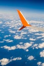 Breathtaking view. The wing of a small scheduled plane against the blue sky, clouds of the sea surface below. View from the Royalty Free Stock Photo