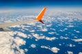 Breathtaking view. The wing of a small scheduled plane against the blue sky, clouds of the sea surface below. View from the Royalty Free Stock Photo