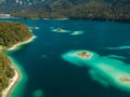 Breathtakingly beautiful aerial view of an island in the teal waters of Lake Eibsee in Bavaria