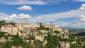 Breathtakingly picturesque sky with floating white clouds over medieval Gordes village, rock and Luberon valley. Vaucluse, Royalty Free Stock Photo