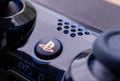 Brecht, Belgium - April 13 2020: A close up portrait of the playstation home button on a PS4 wireless controller. The button has
