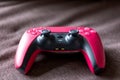 Brecht, Belgium - 14 july 2023: A portrait of a cosmic red official playstation 5 game controller ready to play. the PS5 device