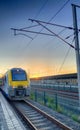 Brecht, Belgium - June 2019: A commuter train in the Noorderkempen railway station in Brecht at sunrise