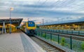 Brecht, Belgium - June 2019: A commuter train in the Noorderkempen railway station in Brecht at sunrise