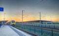 Brecht, Belgium - June 2019: A commuter train in the Noorderkempen railway station in Brecht at sunrise