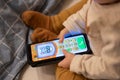Brecht, Belgium - 7 November 2021: A portrait of a toddler playing a video game app on a Android Samsung smartphone. The baby is