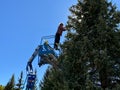 City worker standing in the Genie aerial lift installing Christmas lights