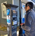 Tourist trying to pay his parking via parking ticket kiosk Royalty Free Stock Photo