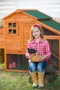 Breeder hens kid girl rancher farmer with chicks in chicken coop