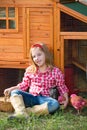 Breeder hens kid girl rancher farmer with chicks in chicken coop Royalty Free Stock Photo