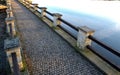 Breeding pond dam. water flows under a stone bridge with several arches. bridge on the crown of the dam with canals for drainage o