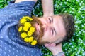 Breeziness concept. Man with beard on smiling face put hands behind head. Guy with dandelions in beard relaxing, top Royalty Free Stock Photo