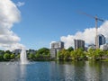 Breiavatnet lake with grass, trees and tall buildings in front of the lake Royalty Free Stock Photo
