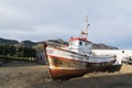 BREIDDALSVIK, ICELAND - AUGUST 2018: abandoned old fishing vessel standing on the ground next to Beljandi Brewery