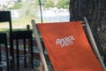 Aperol Spritz logo on orange long chair at the restaurant terrace Royalty Free Stock Photo