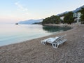Brela, Croatia - July 24, 2021: Loznica beach with beach chairs in a seaside resort. A quiet morning on the Adriatic. Royalty Free Stock Photo
