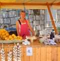 Brela.  Croatia - June 25, 2019: Fair, Beautiful smiling woman stands behind the counter and sells seasonal fruits and vegetables Royalty Free Stock Photo