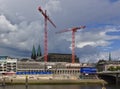 Bremen, Germany - July 10th, 2018 - Construction site of the new Kuehne building on the bank of the river Weser with huge cranes a