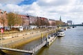 BREMEN, GERMANY - MARCH 23, 2016: A ship in front of historic facades of houses on embankment of Weser river in Bremen, Germany.