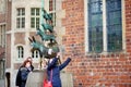 BREMEN, GERMANY - MARCH 23, 2016: Tourists taking pictures of themselves by famous statue in the center of Bremen, known as The Br
