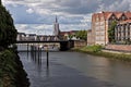 Bremen, Germany - Red brick waterfront buildings and huge bridge across the river Weser with church spire in the distance