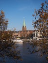 Bremen, Germany - River Weser with St. Martini church framed by trees in the foreground with slanted horizon Royalty Free Stock Photo