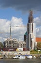 Bremen, Germany - September 14th, 2017 - Riverside construction site with cranes, partly and fully completed residential buildings