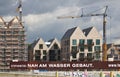 Bremen, Germany - September 14th, 2017 - Riverside construction site with cranes, partly and fully completed residential buildings