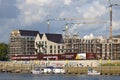 Bremen, Germany - September 14th, 2017 - Riverside construction site with cranes, partly and fully completed residential buildings