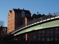 Bremen, Germany - Steel bridge across the river Weser leading to the Teerhof peninsula with red brick buildings in the background