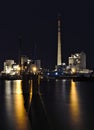 Bremen, Germany - View across the harbor at night at various brightly illuminated industrial plants and port facilities