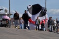A large inflatable shark kite on the ground behind people in Bremerhaven, Germany