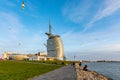 Bremerhaven, Germany - 2 Nov 2019: People playing with seagulls on Weser river Promenade am Strom riverfront embarkment in sunset