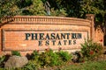 Brentwood, California October 20, 2023: Pheasant Run Estates entrance in Brentwood, California with a gate, green trees and a