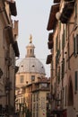 Narrow street with dome of Saint Mary of the Peace Church, Brescia Old Town, Lombardy, Italy