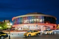 Brest, Belarus. Cinema Belarus On Sovietskaya Street In Evening Night Illuminations. Basis Of Round Building Of Cinema