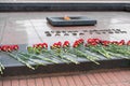 BREST, BELARUS - JULY 28, 2018: Flowers on the Tombstone of Unknown Soldier and Eternal Light. The title says `Glory to the Heroe