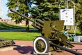 Historical artillery gun on the wheels from the World War II age. Close up of a retro military cannon weapon