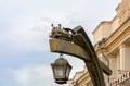 In Brest, at the railway station, not far from ticket offices, a pointer in the form of a lantern is installed. Near a fashionable Royalty Free Stock Photo