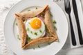 Breton crepe, Savory Buckwheat Galettes Bretonnes with fried egg, cheese, ham closeup on the plate. Horizontal top view Royalty Free Stock Photo