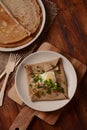 Breton galette, galette sarrasin, buckwheat crepe, with fried egg, cheese, ham. Royalty Free Stock Photo