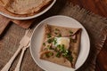 Breton galette, galette sarrasin, buckwheat crepe, with fried egg, cheese, ham. Royalty Free Stock Photo