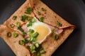 Breton galette, galette sarrasin, buckwheat crepe, with fried egg, cheese, ham. Royalty Free Stock Photo
